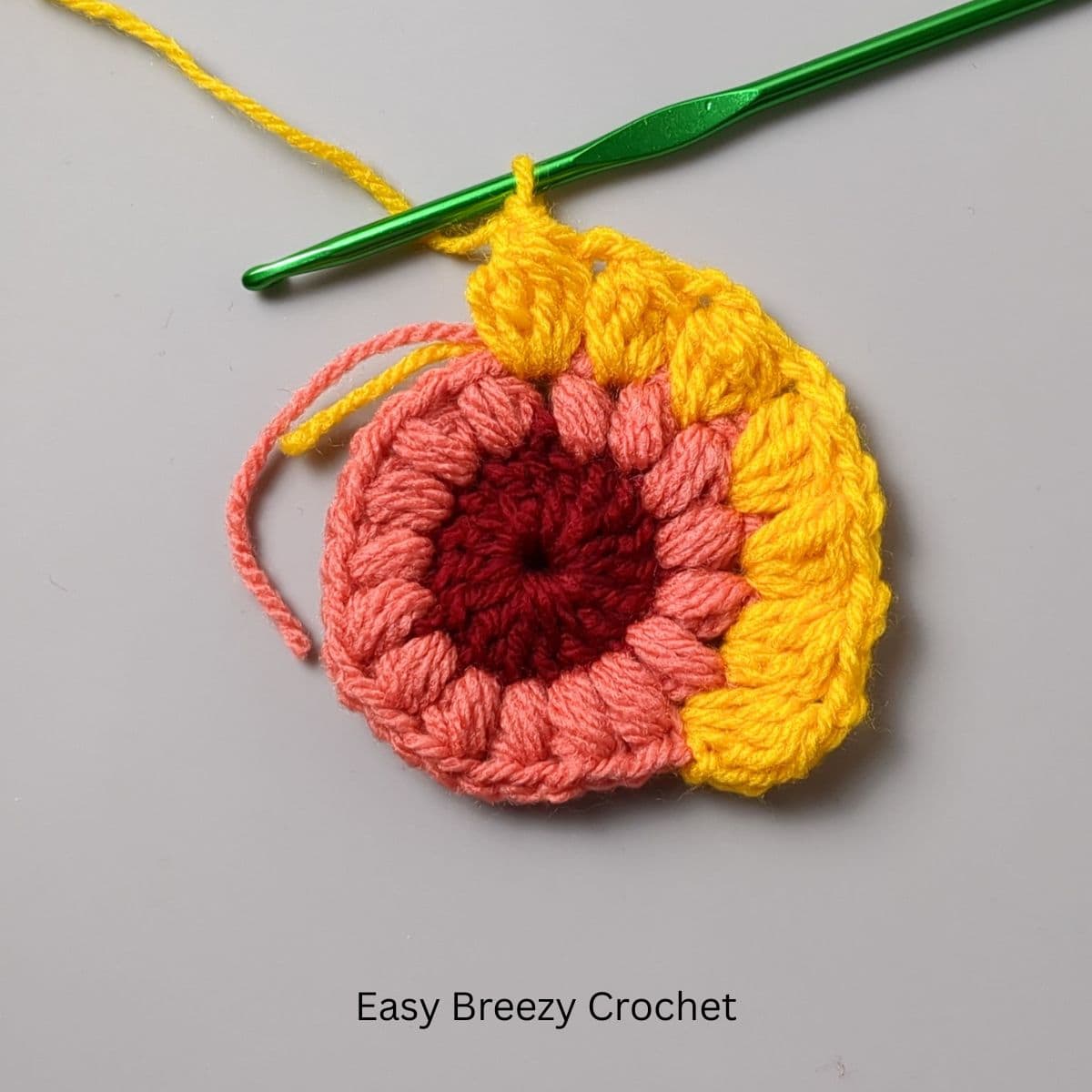 A round of double crochet cluster stitches.