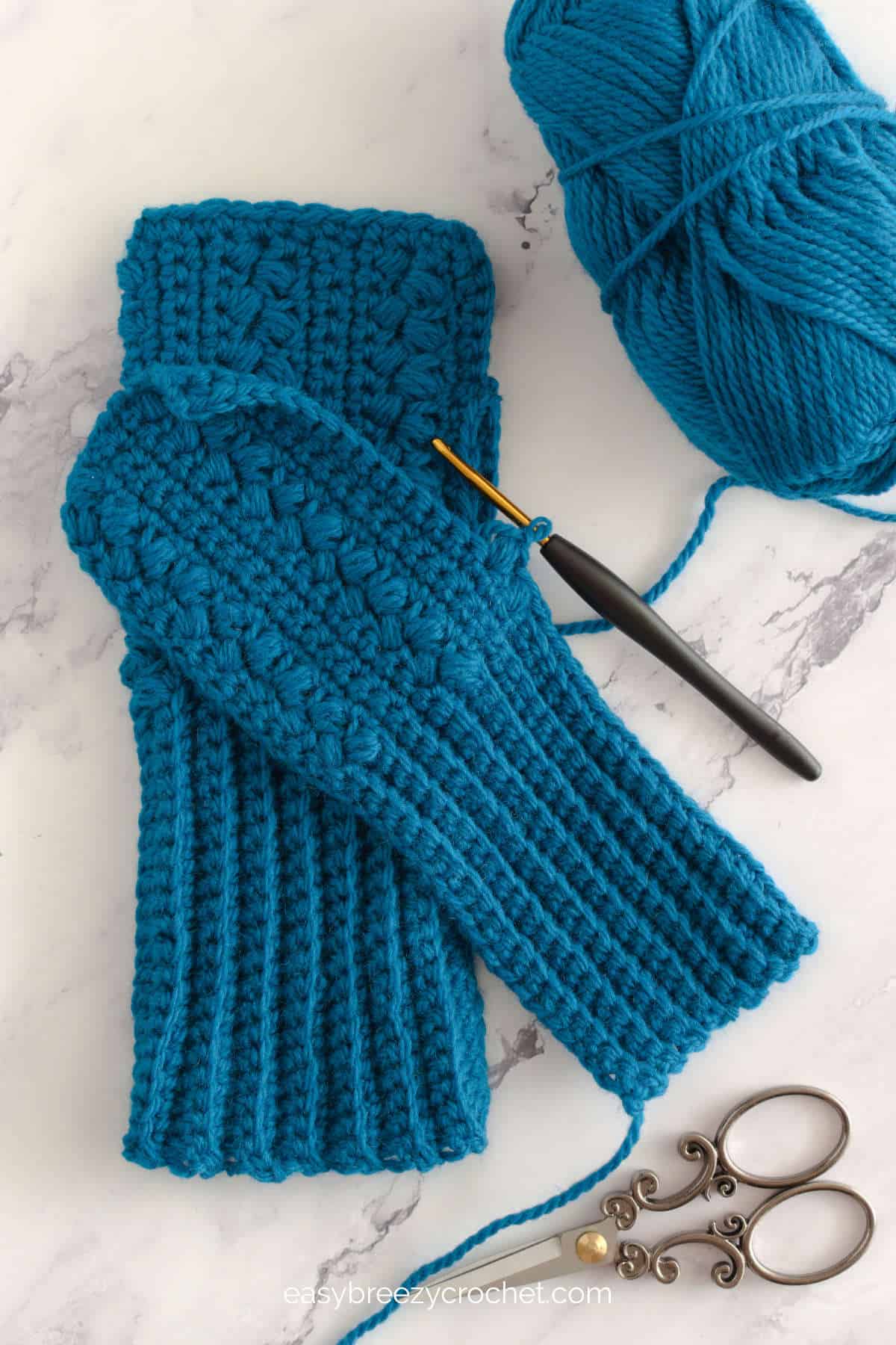 Image showing a work in progress of crochet fingerless gloves.