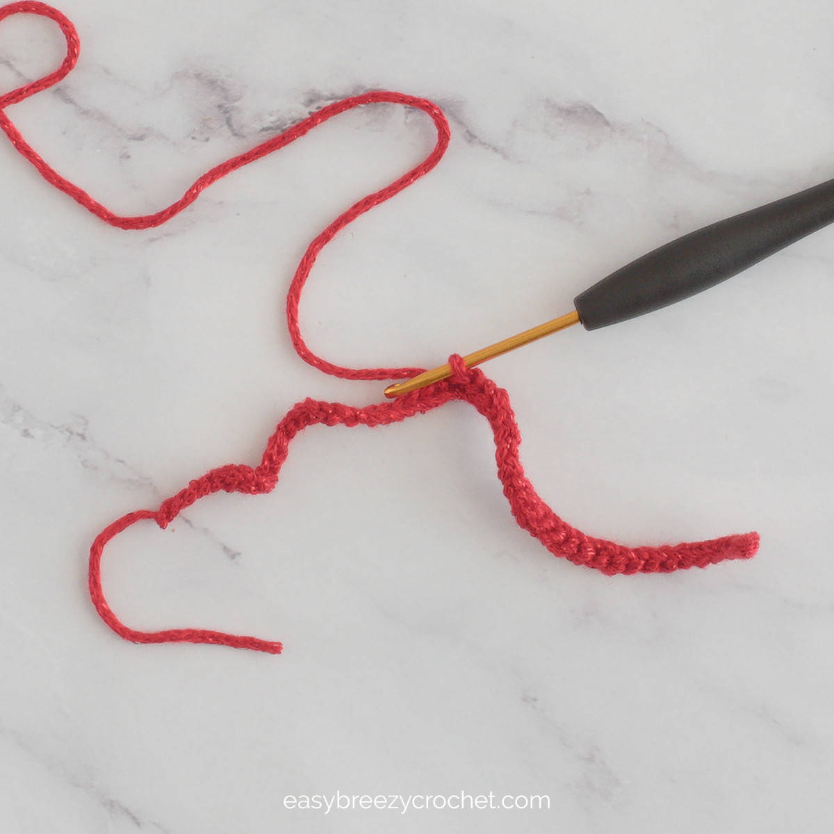 A length of crocheted red yarn to make a bow.
