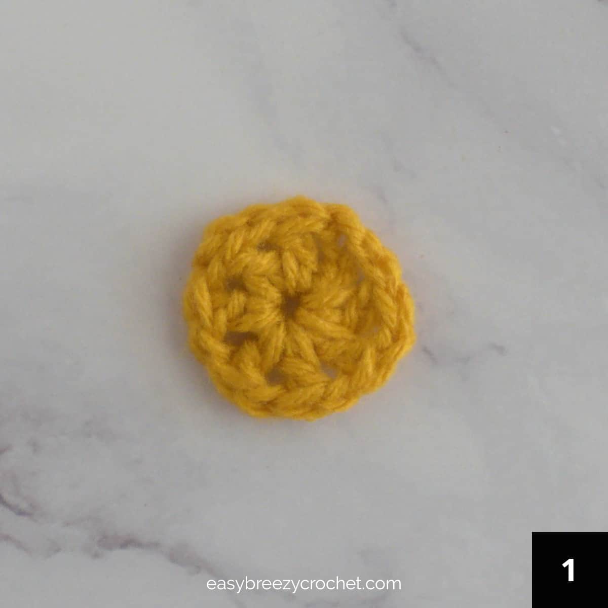 A gold colored single round crochet circle.