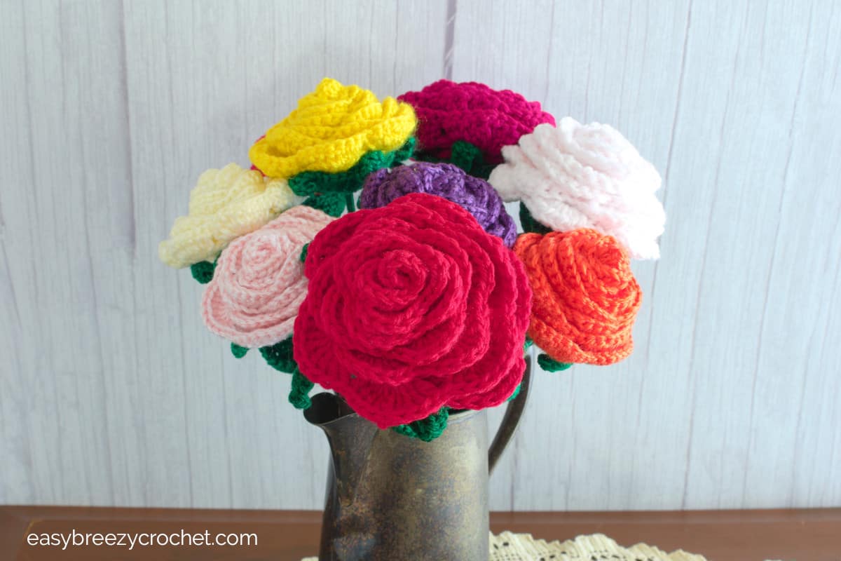 A close of of different colored crocheted roses.