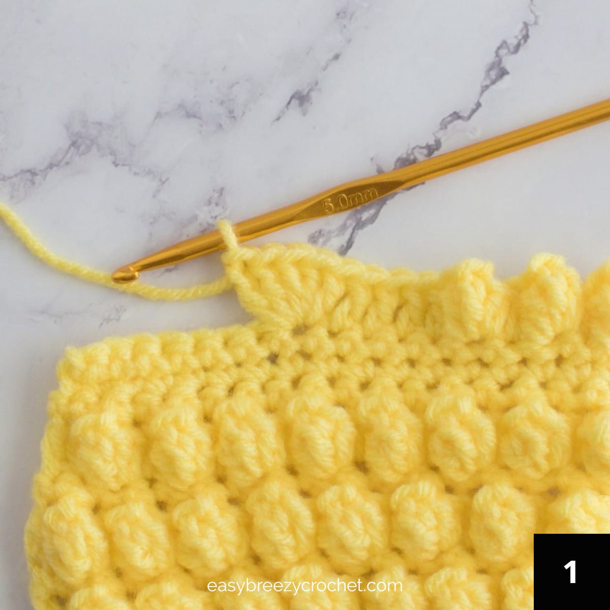 Five double crochet stitches made in one stitch.