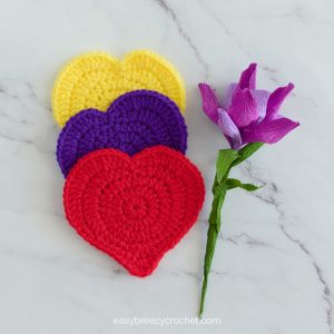 Three crochet heart coasters.
