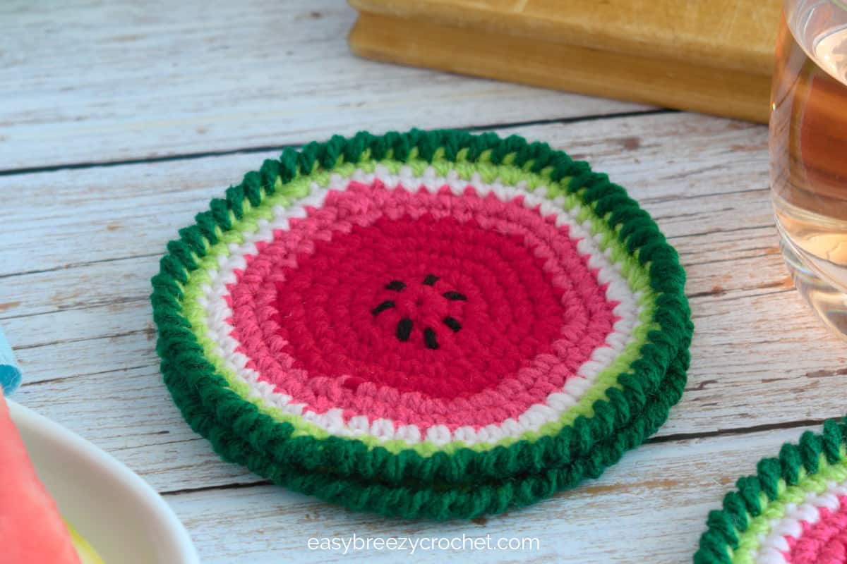 A closeup of crochet watermelon coasters.