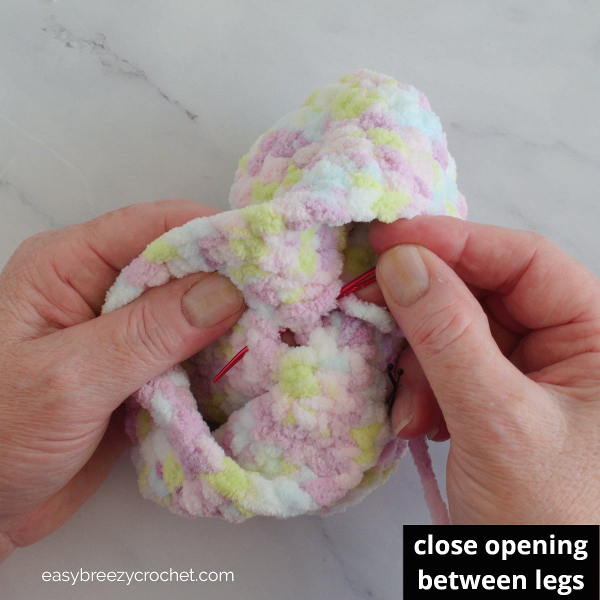 Sewing closed and opening in a crochet piece.