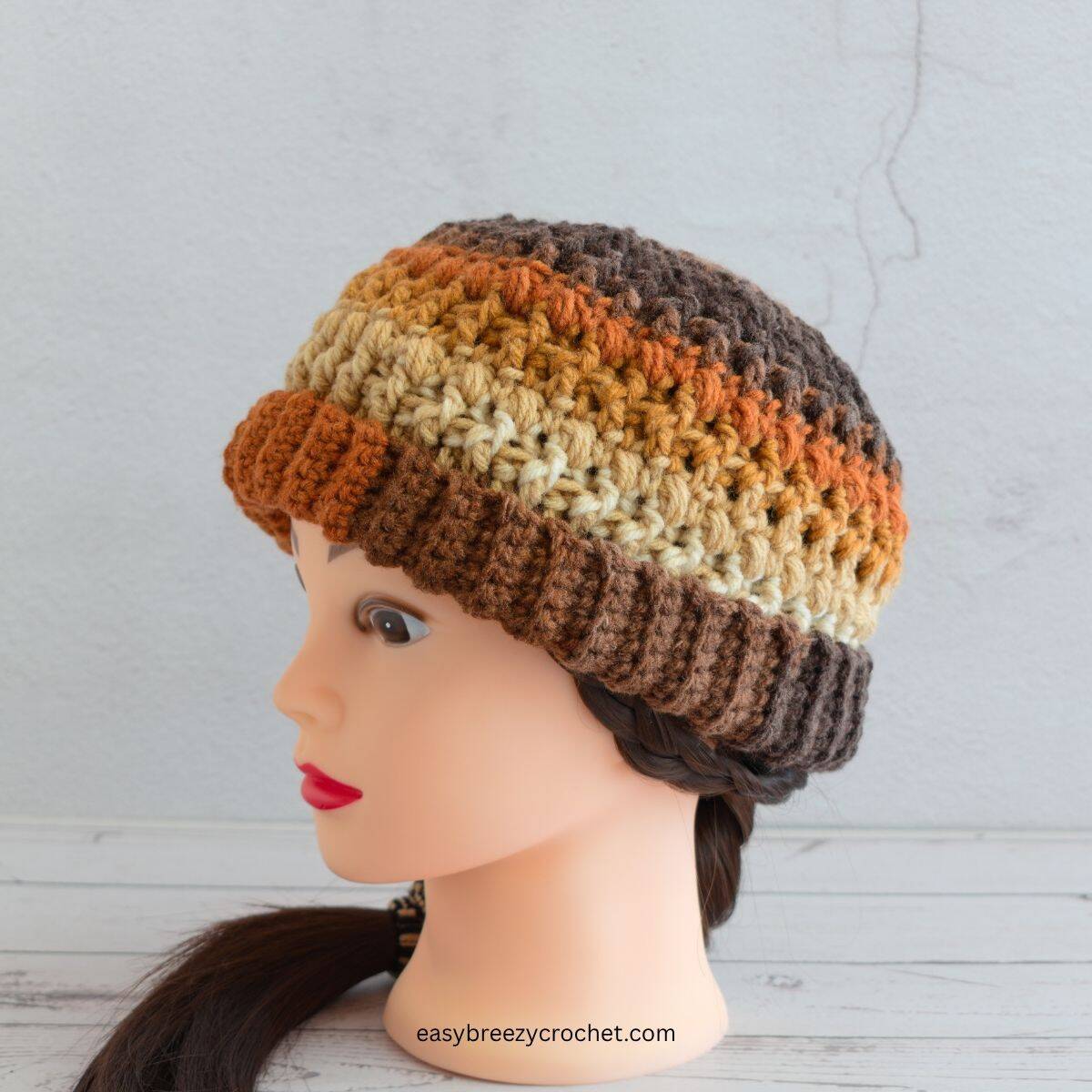 A multi colored brown crochet beanie.