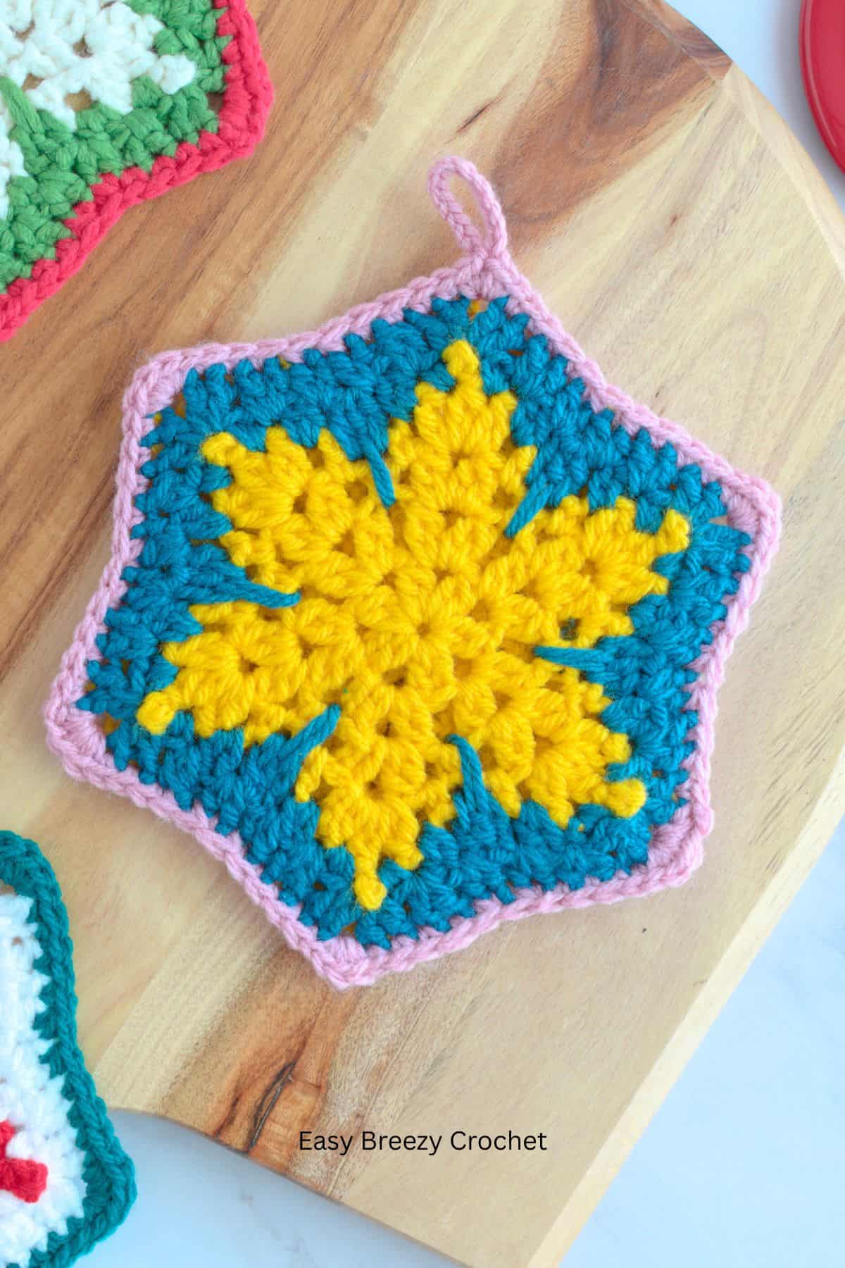Yellow and blue crochet hot pad.

