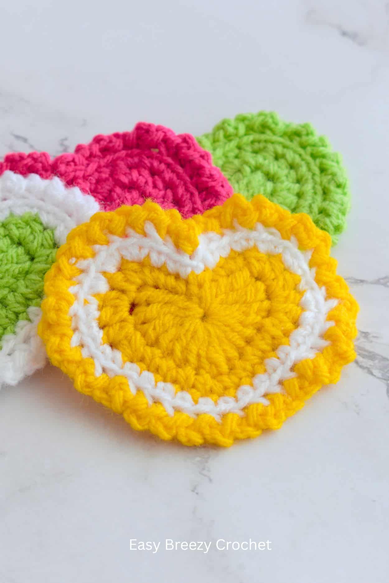 A yellow and white crochet heart.