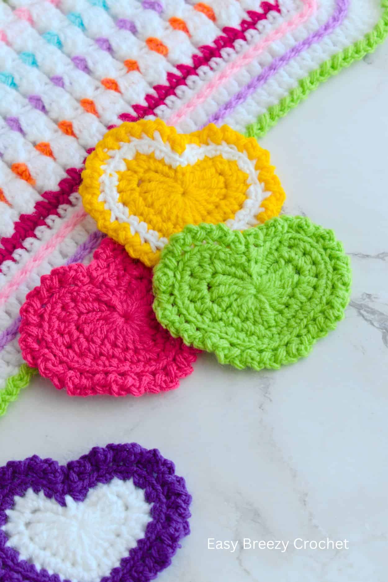 Four crochet hearts.
