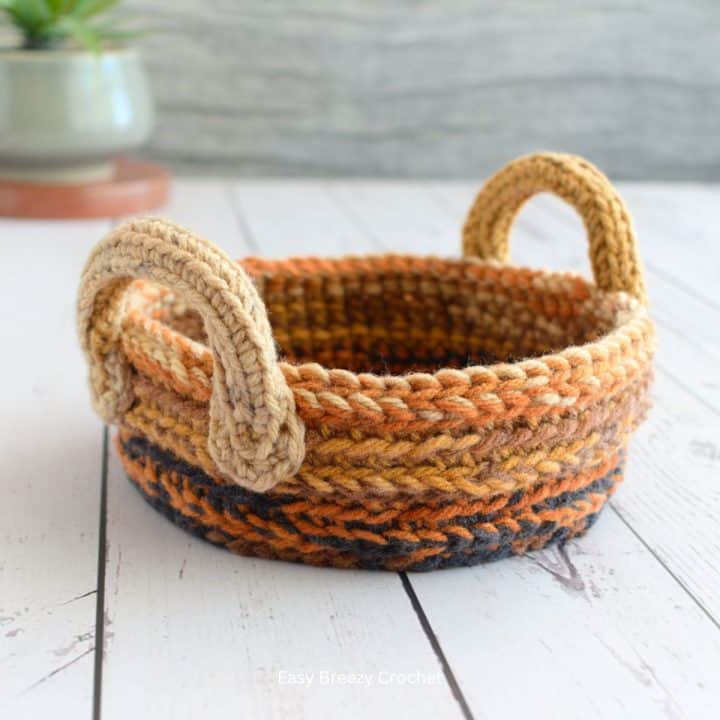 Small crochet basket with handles.
