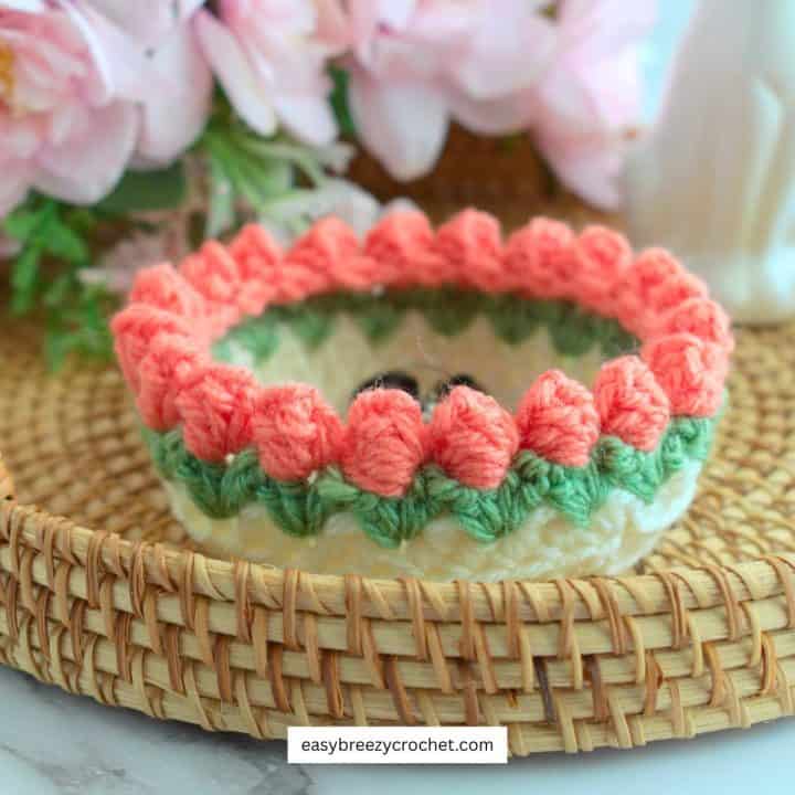 A crochet tulip trinket dish in a tray.