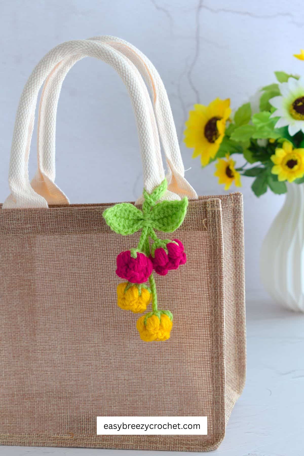 Red and yellow flower bag charm.