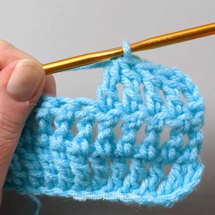 Treble crochet 2 together.