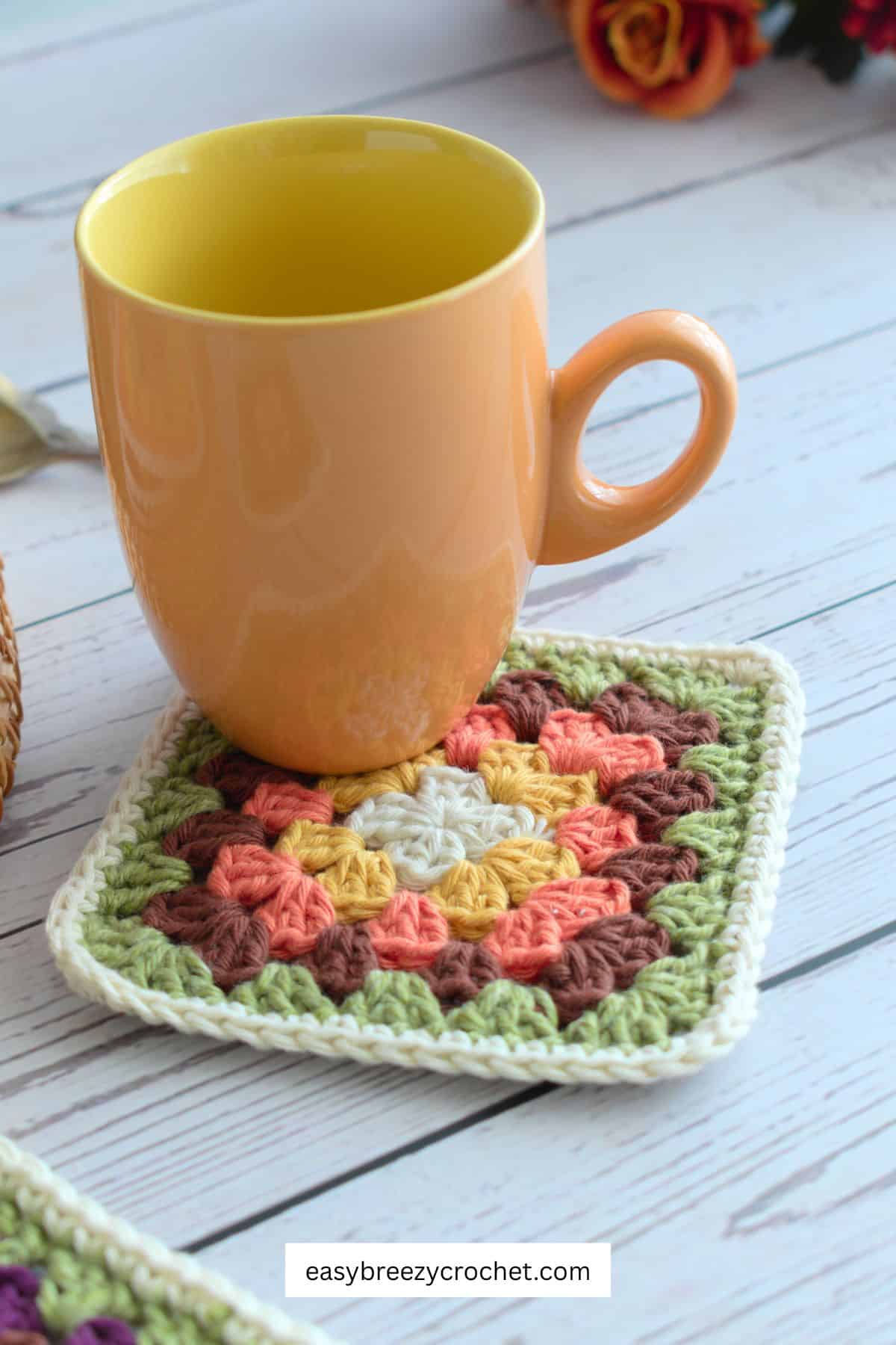 Mug on a granny square coaster.