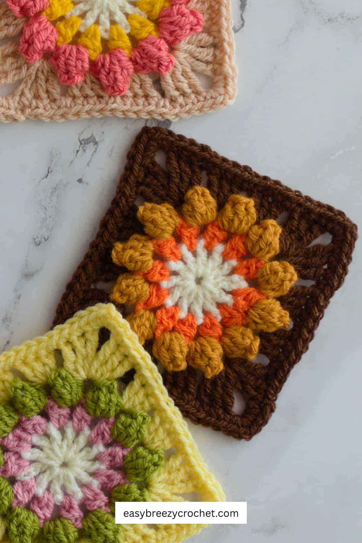 Close up of a brown popcorn flower crochet square.