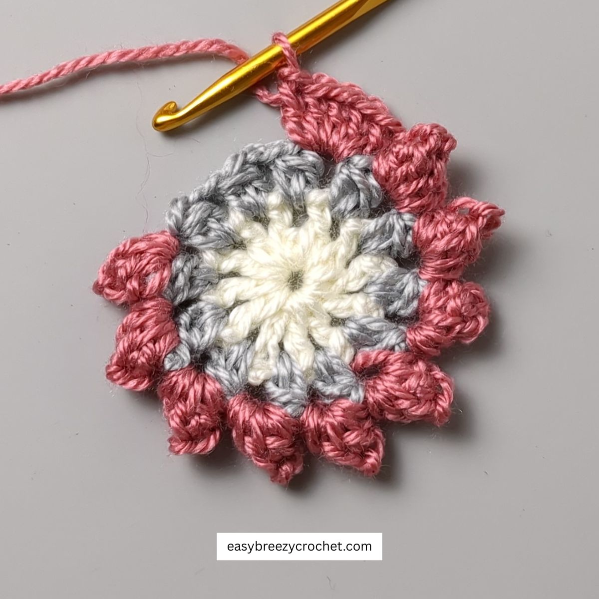 Crochet circle with popcorn stitch border.