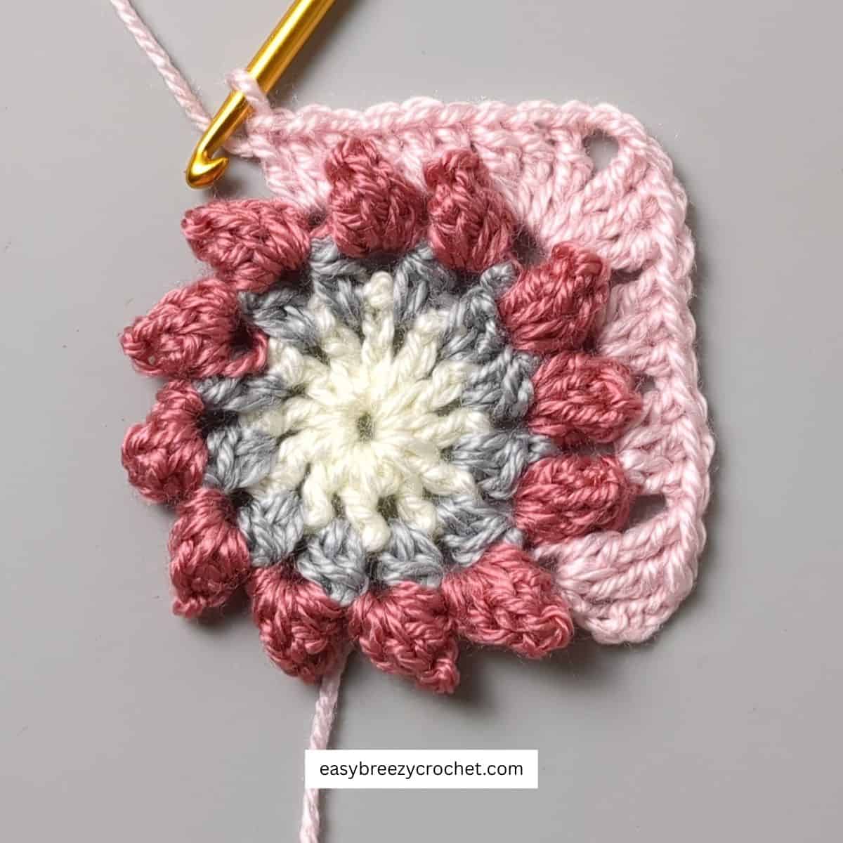 Crochet circle with being shaped into a square.