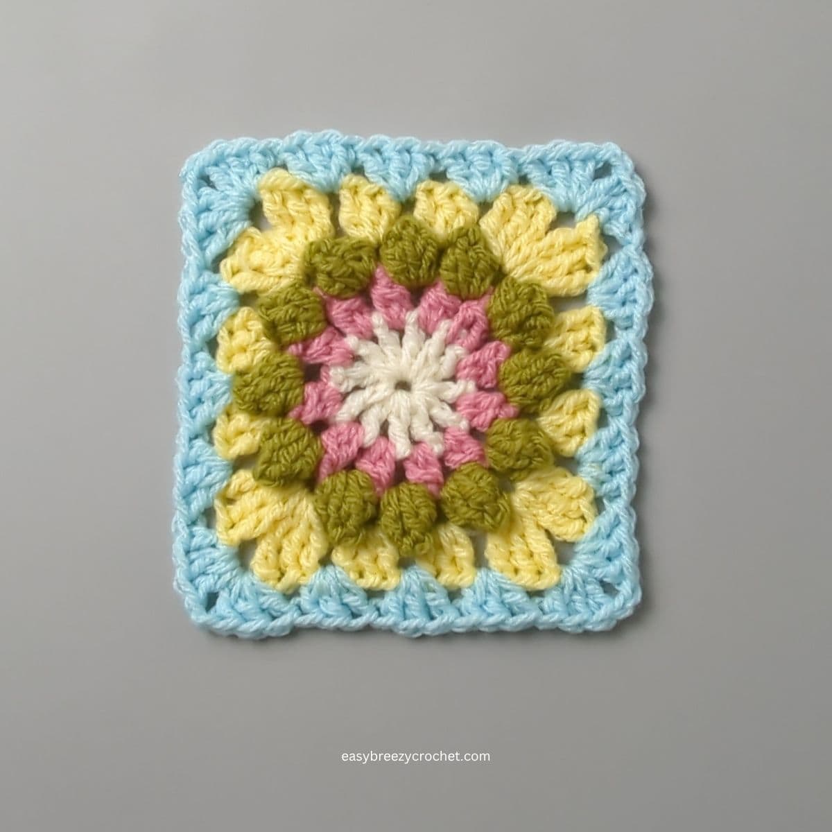 Granny square with blue boarder.